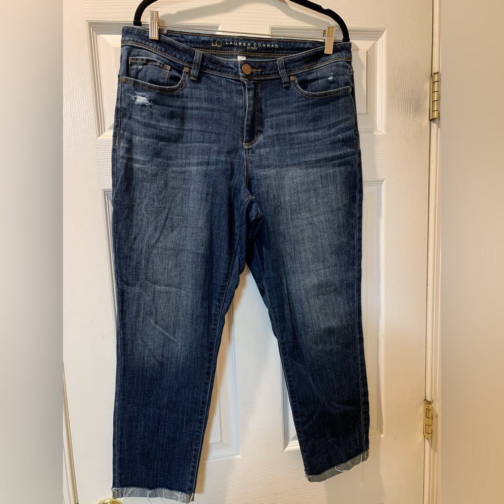 Skinny leg blue jeans with frayed edged fold